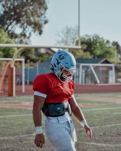 a football player wearing a helmet on the field