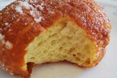 a close up of a doughnut on a plate with powdered sugar sprinkled on it