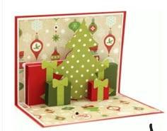 a christmas card with a tree and presents on it's side, in front of a white background