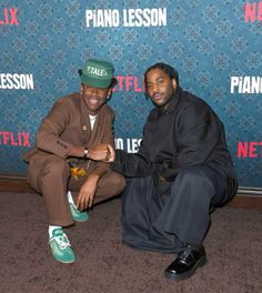 two men sitting next to each other on the carpet