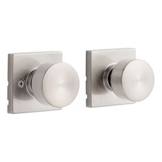 two white knobs on the side of a door