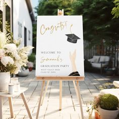 an easel with a sign that says congratulations to someone's graduation party on it