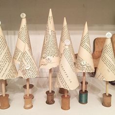 several small wooden christmas trees are lined up on top of each other, with words written in them