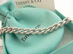 Offered for sale is a wonderful and rare Tiffany and Co. Sterling Silver "I Love You" Heart Padlock bracelet. The piece is made from substantial and bright Tiffany silver, and yet retains a very feminine feel to it. Attached to its very substantial Tiffany Silver Textured charm bracelet is a Heart padlock charm with "I Love You" written in beautiful script. The "I Love You" heart padlock charm opens and closes and thus can be used as a charm on a necklace or as part of another charm bracelet! Su Padlock Bracelet, Heart Padlocks, Tiffany And Co, Tiffany Heart, Heart Charm Bracelet, Tiffany & Co., Infinity Bracelet, A Heart, I Love You