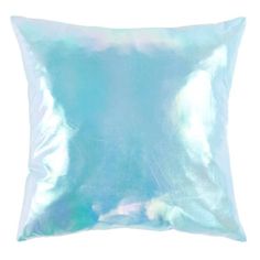 a blue pillow on a white background with an image of clouds in the sky behind it