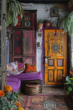 a room filled with lots of colorful furniture and flowers on the floor next to a yellow door