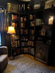 a living room filled with lots of books and furniture