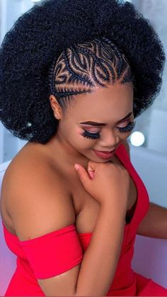 a woman with an afro is smiling and looking at the camera while wearing a red dress