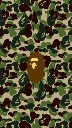 a gorilla face on camouflage background with green and brown colors in the foreground, there is