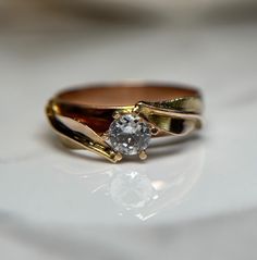 a gold ring with a diamond on it