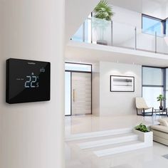 thermostaer is mounted on the wall in this modern living room