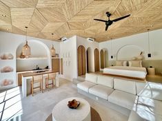 a bedroom with white furniture and wooden ceiling