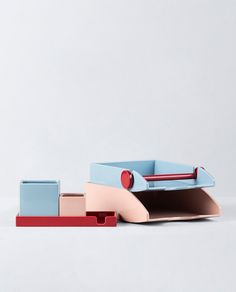 two pieces of furniture sitting next to each other on top of a white surface with red and blue accents