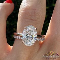 a woman's hand with a ring on it and a diamond in the middle