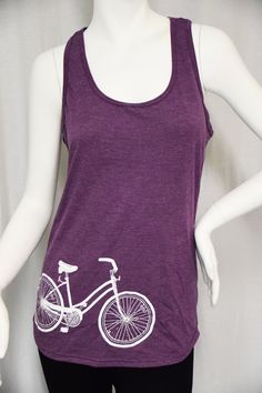 The bicycle tank is 4.7 oz., 50/25/25 polyester/combed ringspun cotton/rayon item. The bicycle is hand screen printed in white ink on this beautiful semi-fitted racerback tank. Colors: heather dark grey & heather purple Womens Tank Tops, Heather Purple, Hand Screen Printed, White Ink, Womens Tank, Racerback Tank, Womens Clothing Tops, Dark Grey, Screen Printing