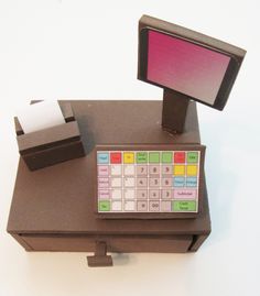 a small electronic device sitting on top of a wooden table next to a tissue dispenser