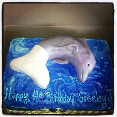 a birthday cake with a dolphin on it