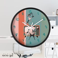 a wall clock with an image of a cat sitting on top of a tv set