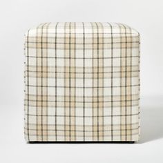 a beige and black plaid ottoman