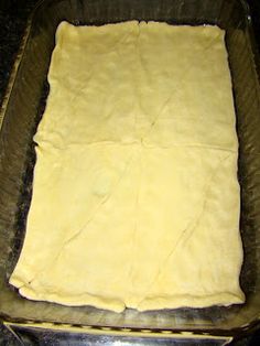 an uncooked pizza dough in a glass dish