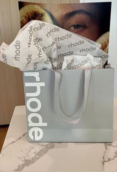 a bag that has some paper in it on top of a marble counter with the word poopie printed on it