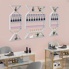 two tables and chairs in front of a pink wall with bottles on shelves above them