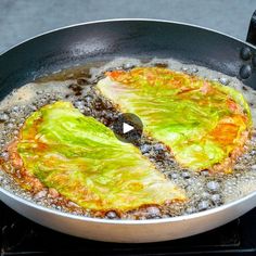 a frying pan filled with food on top of a stove