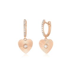 The Gold & Diamond Fluted Heart Drop Huggie Earrings add even more shine to our best-selling Diamond Huggie. With a heart-shaped drop featuring a central diamond set inside a gold sparkle design with fluted lines that beautifully reflect light, this huggie delivers dimension and depth to any look. Rose Gold Diamond Heart Cut Earrings, Rose Gold Heart Cut Diamond Earrings, Rose Gold Heart Earrings With Diamond Accents, Elegant Rose Gold Huggie Heart Earrings, Elegant Rose Gold Diamond Heart Earrings, Rose Gold Heart Cut Earrings With Diamond Accents, Diamond Heart Drop Earrings Fine Jewelry, Elegant Heart Charm Huggie Earrings, Heart-shaped Diamond Earrings With Accents For Valentine's Day