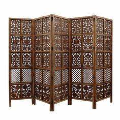 a wooden screen with intricate carvings on the sides and an openwork design in the middle