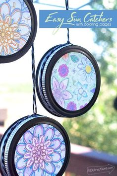 three sun catchers hanging from a wire with flowers painted on them and the words easy sun catchers