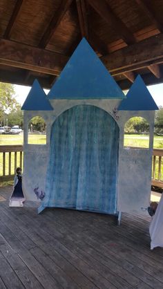 an outdoor stage set up for a children's birthday party with blue and white tents