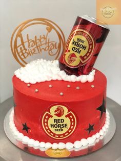 a birthday cake with a red horse beer on top