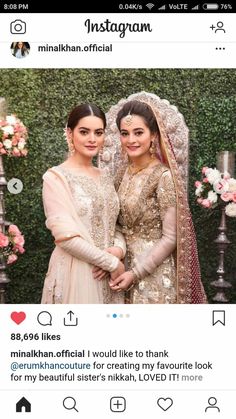 two women standing next to each other in front of a flower covered wall with the caption instagram