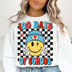 a woman wearing a white sweatshirt with the words 100 days of school on it and a smiley face