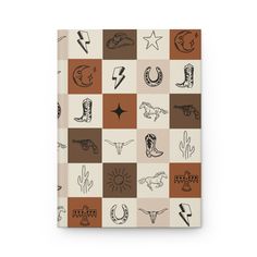 a notebook with different designs on the cover, including cowboy symbols and other things in brown