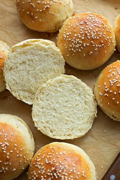 rolls with sesame seeds are on a cutting board