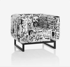 a black and white chair with graffiti on it