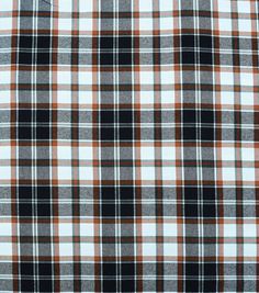 an orange and black plaid fabric with white, brown, and blue checks on it