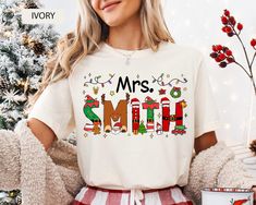 a woman wearing a mrs smith christmas t - shirt