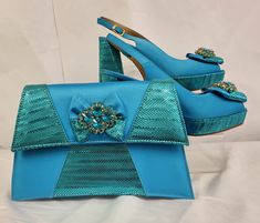 This blue  matching bag and shoe set is designed to meet your party needs. It will enable you to stand out and look your very best! Sizes available in EU 40. The heel is about 4 inches/ 10.16 centimetres  Material is Italian Leather Please message if you have any further inquiries! Thank you Formal Blue Bags For Summer, Turquoise Satin Shoes, Luxury Turquoise Evening Bag, Luxury Green Bags With Gold-tone Hardware, Luxury Green Bags With Silver-tone Hardware, Luxury Blue Bag With Silver-tone Hardware, Italian Shoes, Party Needs, Beauty Shop