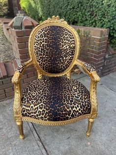 a leopard print chair sitting on top of a sidewalk