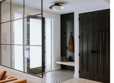 a black and white tiled floor in a room with mirrors on the wall above it