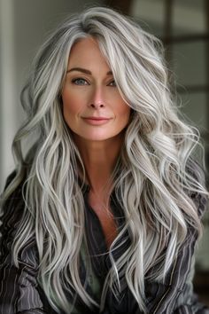 Tailor your hairstyle to enhance your piercing green eyes with long, wavy locks that showcase a smooth balayage. These hair styles for women over 50 add a touch of elegance to your everyday look. Wavy Grey Hair, Long Hair Over 50 Older Women, Over 50 Long Hair, Long Gray Hair Over 50, Graceful Aging, Long Hair Older Women, Long Hairstyles For Women, Grey Hair Over 50