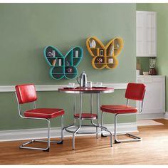 two red chairs are sitting at a round table