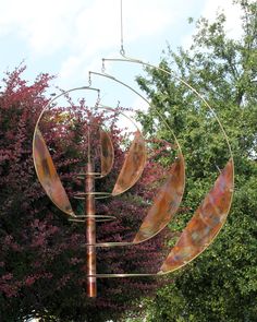 a wind chime hanging from the side of a tree