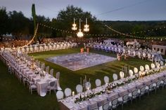 an aerial view of a wedding reception with tables and chairs set up in the shape of a square