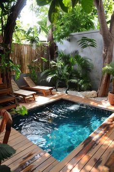 a small pool surrounded by trees and chairs