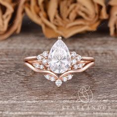 a rose gold ring with a pear shaped diamond in the center