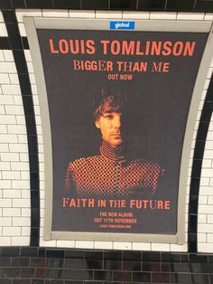 a subway station with a large poster on the wall