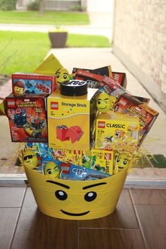 a yellow basket filled with legos and other toys